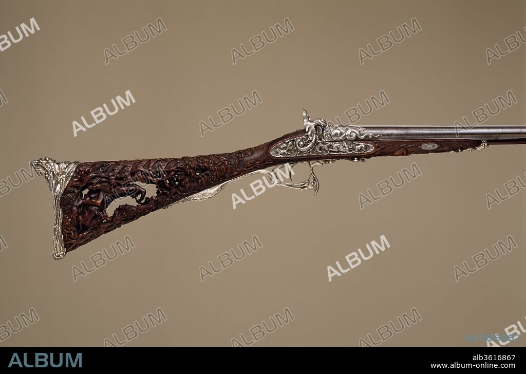 Double-Barreled Percussion Shotgun. Barrelsmith: Léopold Bernard (French, Paris, active 1832-70). Culture: French, Paris. Dimensions: L. 46 3/5 in. (118.4 cm); L. of barrel 29 1/8 in. (73.9 cm). Gunsmith: Louis Perrin (French, Paris, active 1823-65). Date: dated 1854.
This is presumably the "richly decorated gun" said to have been exhibited by Perrin in 1855 at the Exposition Universelle in Paris and again in 1862 at the International Exhibition in London. Undoubtedly Louis Perrin's masterpiece, this shotgun is one of the most ambitious firearms of its period. The butt, pierced and carved in the round with the figure of a medieval hunter, reflects the lingering influence of the Gothic revival. The silver mounts are of extraordinary quality, notably the buttplate with its graceful figure of a Native American.