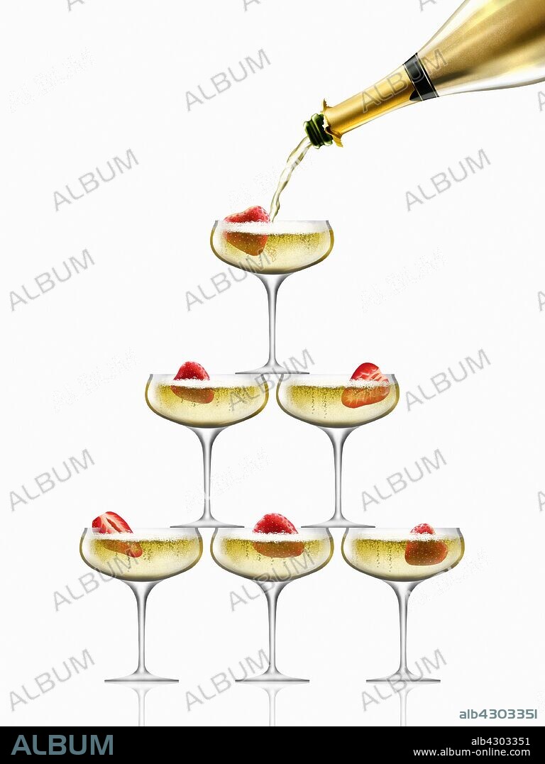 Gold champagne bottle filling coupe glasses in champagne pyramid.