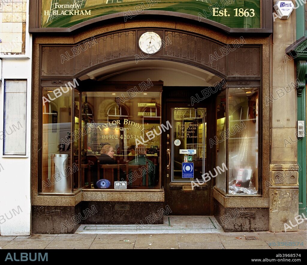 Optician's in Lichfield Street, Wolverhampton, West Midlands, 2001. The facade of this optician's shop in Lichfield Street, Wolverhampton, shows the influence of the art nouveau style. A barometer is set over the window.