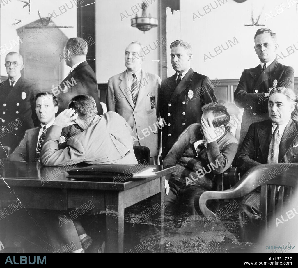 Mafia trial USA.. Louis "Lepke" Buchalter, facing front, seated with Emanuel "Mendy" Weiss and Phillip "Little Farvel" Cohen who shield their faces, and Louis Capone, in a Kings County Courtroom during jury selection 1941.