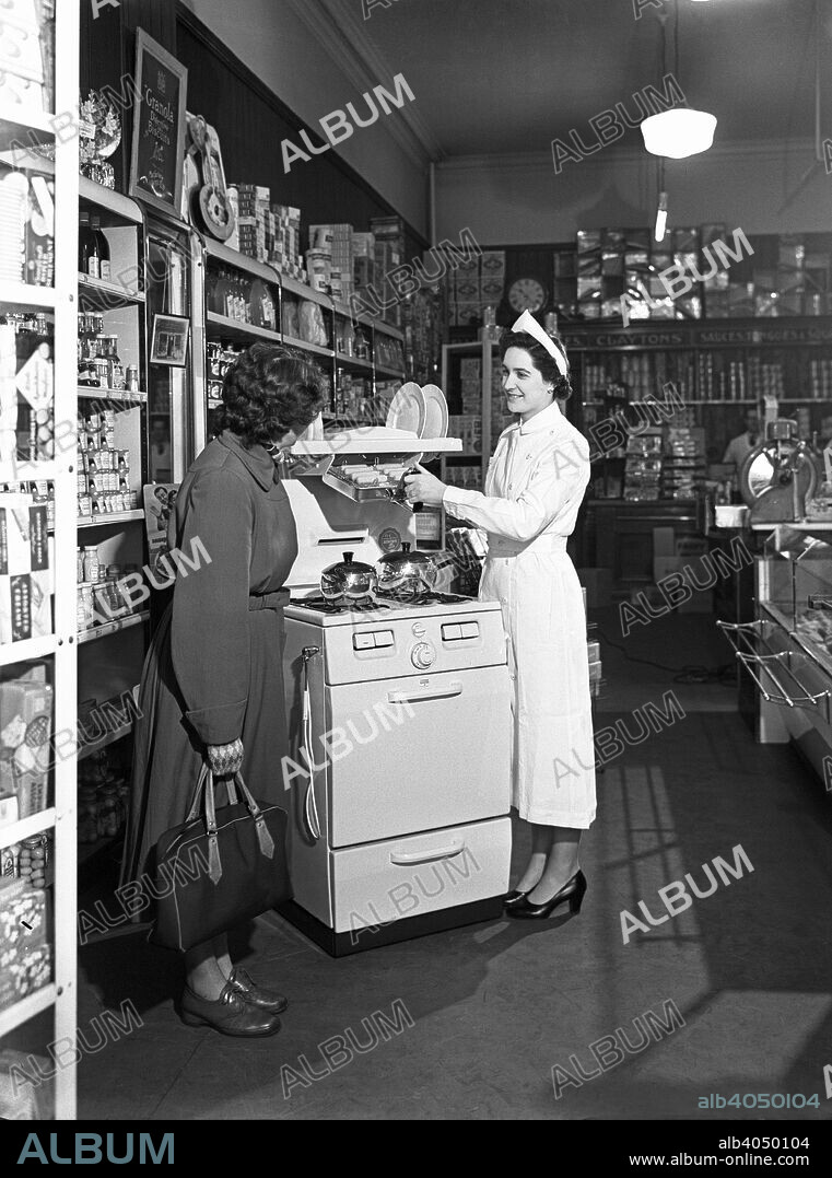 East Midlands Gas Board promotion, Mexborough, South Yorkshire, 1957. A display for the East Midlands Gas Board in 1957 to promote the use of Gas ovens for cooking. The Gas Board and the National Coal Board (who produced gas from coal) were in competition with each other during the 1950s and 1960s and many of these types of promotions were run by both suppliers. This display was in Claytons in Mexborough, which is close to Doncaster.