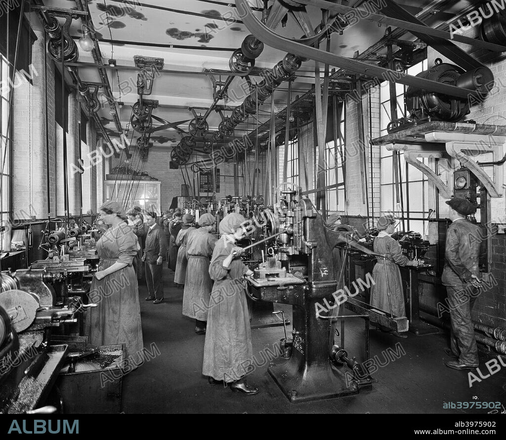 The Birmingham Small Arms factory, Small Heath, Birmingham, February 1917. Men and women working on the machines in machine shop number five during the First World War. One of series of photographs of the BSA factory which produced rifles, Lewis guns, shells and military vehicles.