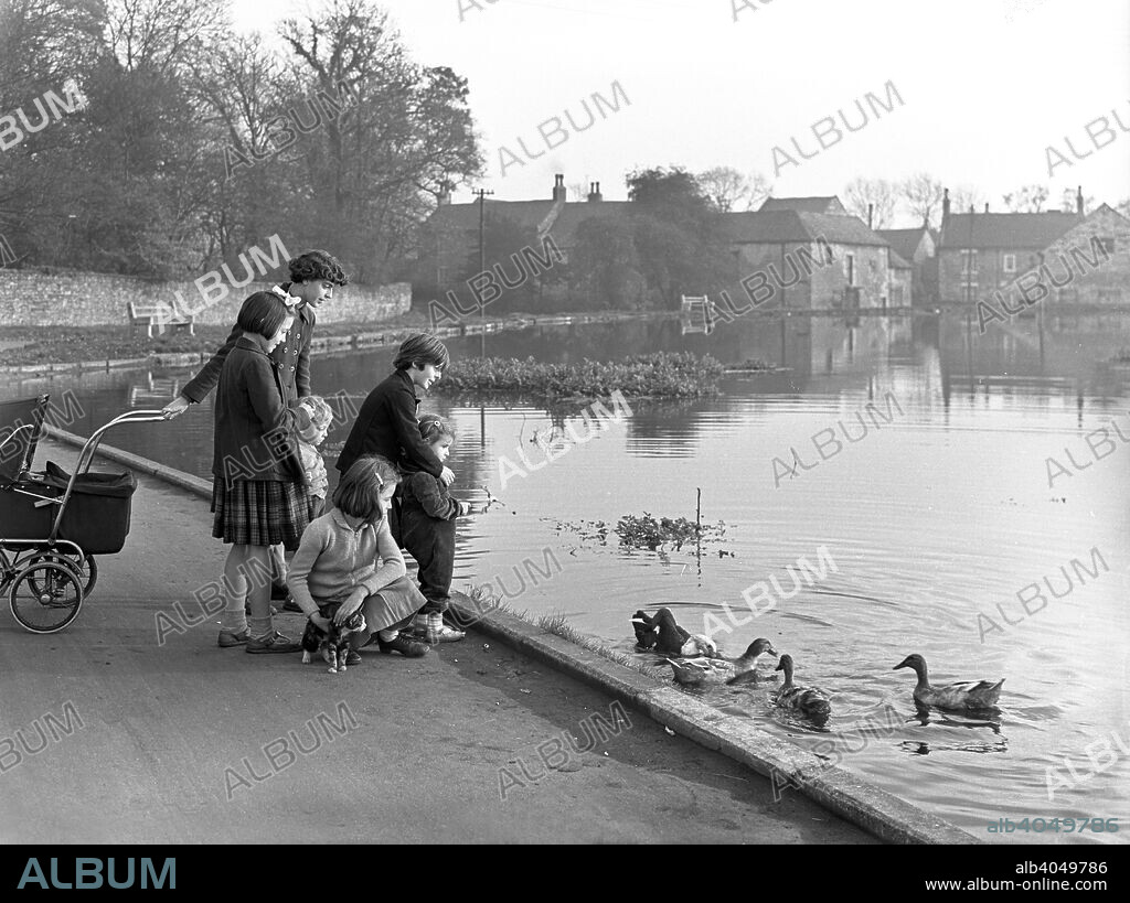 Village duck pond scene, Tickhill, Doncaster, South Yorkshire, 1961. Little has changed in this pleasant scene taken in the village of Tickhill near Doncaster in November of 1961. Some of the buildings in the village can be traced back to Norman times. Tickhill had a castle and to the left of the pond can be seen part of the castle walls, which were severely damaged during the Civil War. Much of the moat, garden and curtain walls still remain today however.
