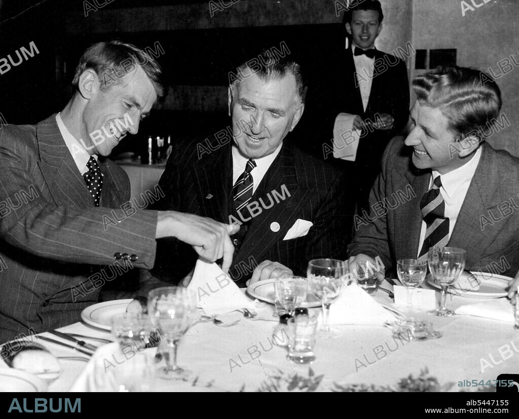 The conqueror of Mt Everest, Sir Edmund Hillary used a table napkin to show the Prime Minister of New Zealand, Mr. Holland how the climb was planned when they met for the first time at dinner at the Australia hotel tonight. At right is George Lowe another member of the successful climbing team. August 7, 1953. (Photo by Frank Albert Charles Burke/Fairfax Media).