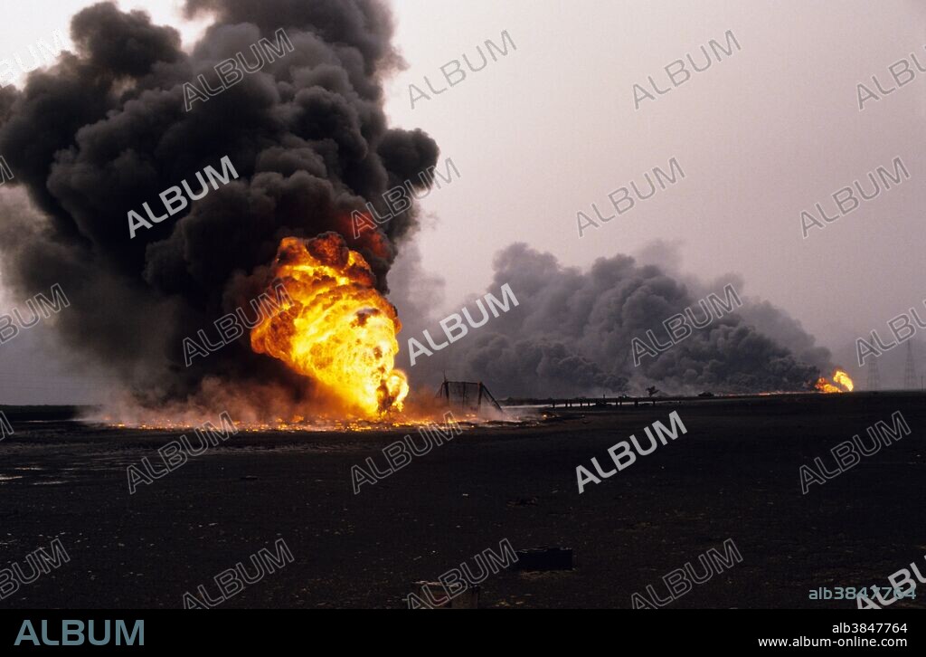 Kuwait City, Kuwait; March 1991. Oil wells burning out of control in the Al-Ahmadi oil fields located on the outskirts of Kuwait City. The oil fields were set on fire by retreating Iraqi troops hoping to create some cover from American airplanes strafing their positions. The fires and smoke caused one of the greatest environmental disasters of modern times. Nearly 800 oil wells were set ablaze by the retreating Iraqi army and the fires were not fully extinguished until November 6, 1991, eight months after the end of the war. The fires consumed an estimated six million barrels of oil daily. Their immediate consequence was a dramatic decrease in air quality, causing respiratory problems for many Kuwaitis. The sabotage of the oil wells also impacted the desert environment, which has a limited natural cleansing ability. Un-ignited oil from the wells formed about 300 oil lakes that contaminated around 40 million tons of sand and earth.