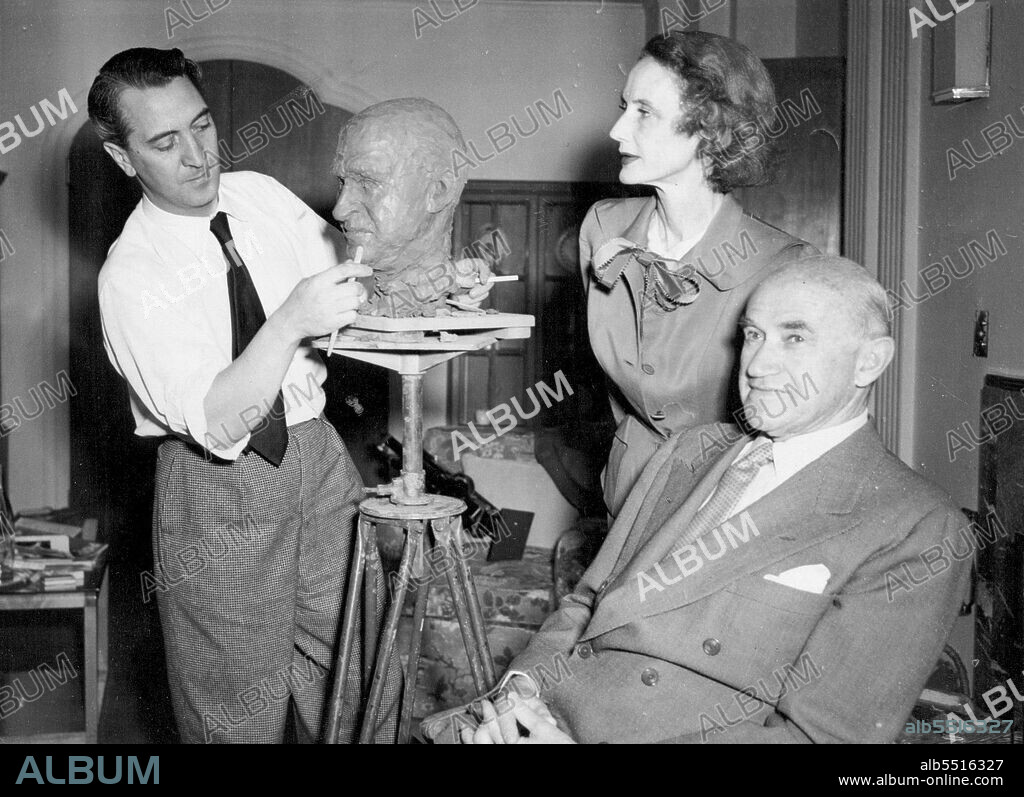 Goldwyn One Of "World's 10 Leading Citizens -- Goldwyn is an interested watcher as her husband, Hollywood film producer Samuel Goldwyn, sits for sculptor Vasco Lazzolo at the Goldwyn's West London hotel.Lazzolo, who recently completed a bust of the Duke of Edinburgh, is doing the Goldwyn bust as one of a set of the "World's ten leading citizens".The Goldwyns are in London for a short holiday trip. May 7, 1953. (Photo by United Press Photo).