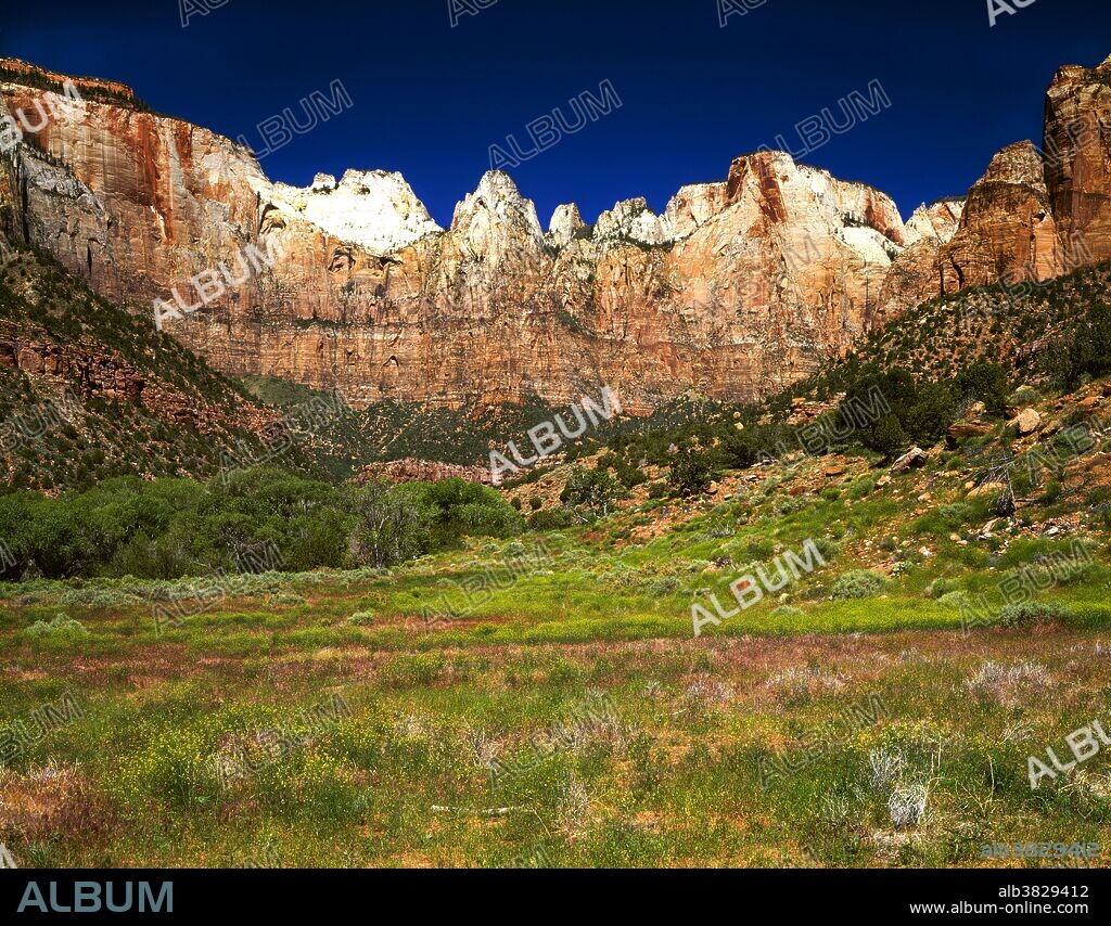 View of Towers of the Virgin, in Zion National Park. On the left is the West Temple. Next to it is the Sundial, and the round rock shape on the extreme right is the Altar of Sacrifice. Zion National Park is located near Springdale, Utah.
