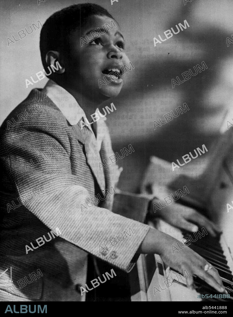 'Sugar Chile' Robinson at the Piano --The vacuum left by the-departure of boxer Sugar Ray Robinson and his colourful circus of assistants and Supporters will be filled next Saturday. On that day a new entertainment Organisation flies into London,Heading it is Frank Issac Robinson, 11-year old boogie-woogie thumping phenomenon of the piano. His trade name is 'Sugar Chile', his entourage consists of a tutor, an attorney, a personal manager, and his father who is taking I holiday from his coal and ice business in Detroit's 'Little Harlem'. The ebony-hued youngster has built big reputation for himself in America. July 23, 1951. (Photo by Reuterphoto).