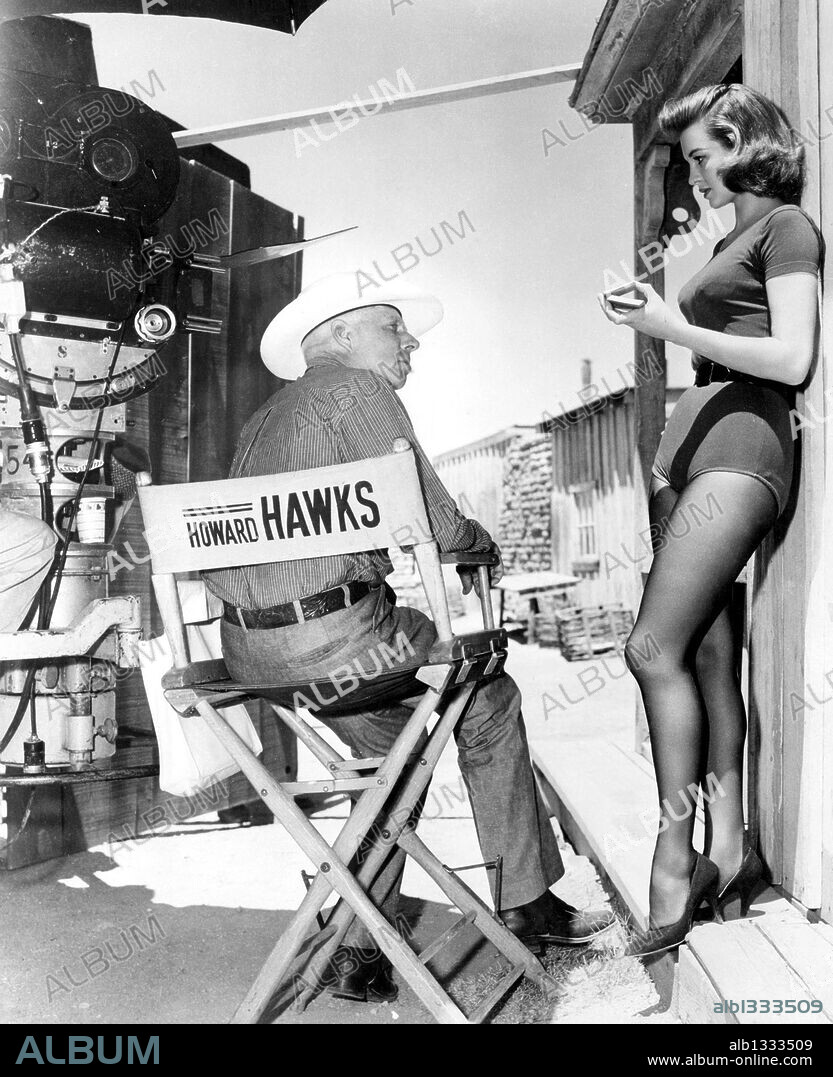 ANGIE DICKINSON and HOWARD HAWKS in RIO BRAVO, 1959, directed by HOWARD HAWKS. Copyright WARNER BROTHERS.
