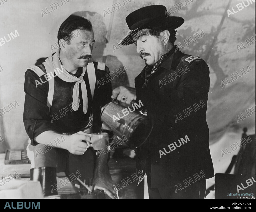 J. CARROL NAISH and JOHN WAYNE in RIO GRANDE, 1950, directed by JOHN FORD. Copyright REPUBLIC PICTURES.