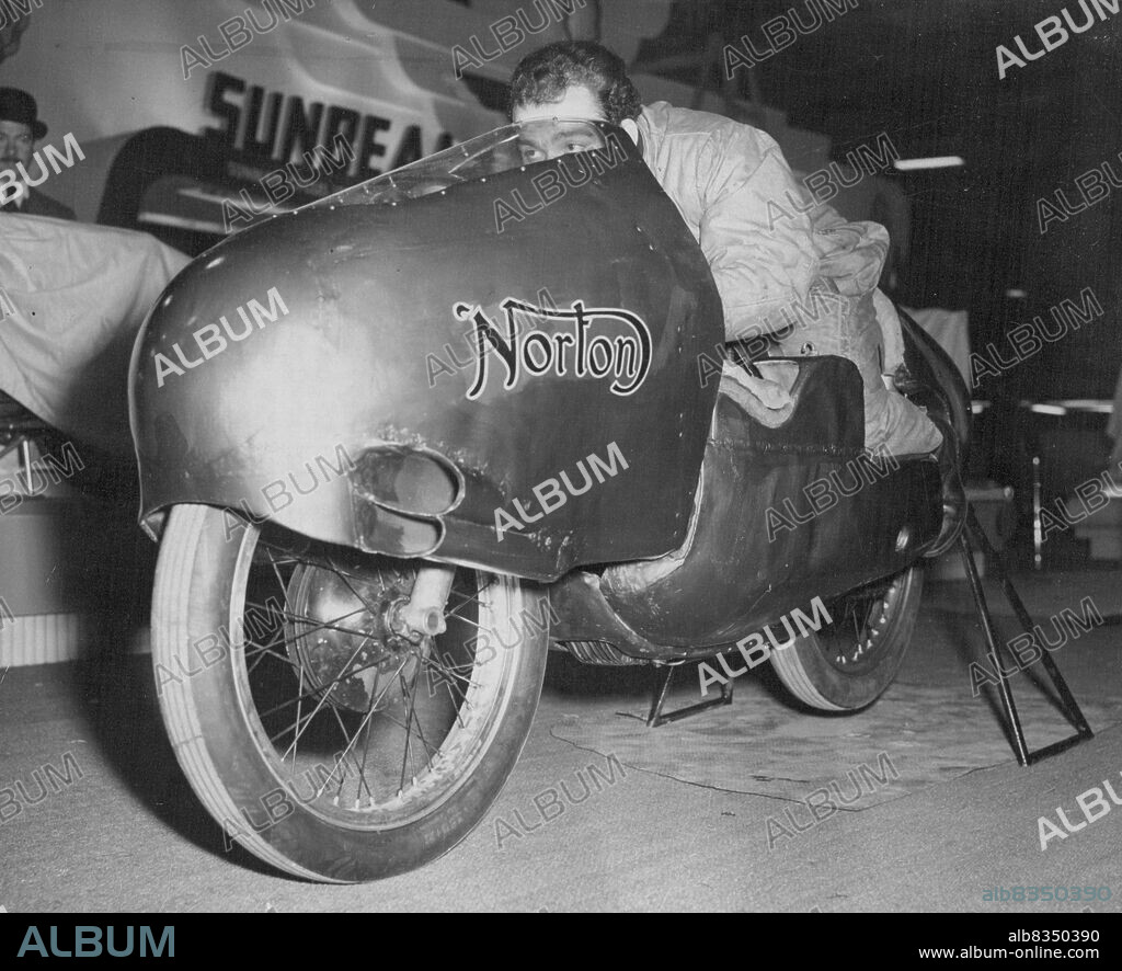 Record-breaking 'Flying Fish' at Motor-Cycle Show.The 'Flying Fish', the streamlined Norton motor-cycle which recently broke the world hour record at 134 miles an hour on the Montlhery track, Paris, pictured to-day (Friday) at Earl's Court, London, where it is to be exhibited in the Cycle and Motor-Cycle Show.The show opens tomorrow until November 21. November 13, 1953. (Photo by Reuterphoto).