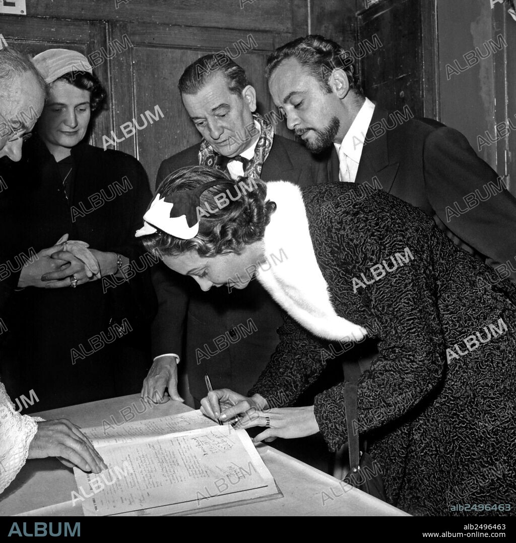 Wedding of Raymond Pellegrin and Gisele Pascal october 8, 1955 in Bures-sur-Yvette, France : here Gisele signing register under look of her husband and Marcel Pagnol.