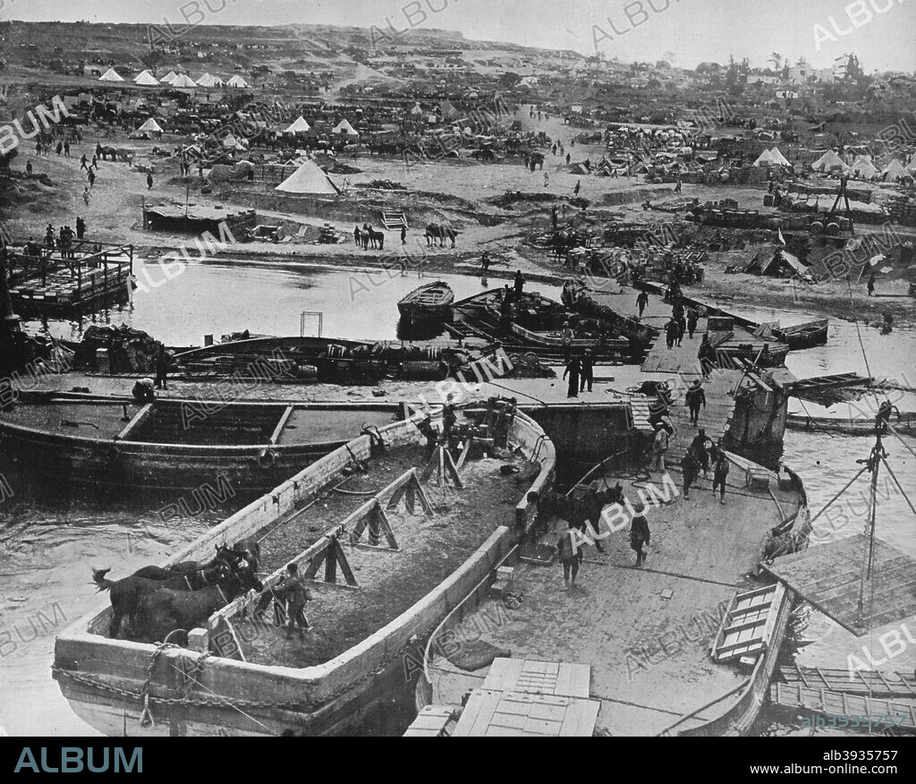 'Landing beach at Sedd el Bahr, as British troops arrived on the Peninsula', 1915. Taken from the beached SS River Clyd  showing the horses, provisions, baggage, etc. going ashore, Sedd el Bahr is a village in the district of Eceabat, Canakkale Province, Turkey.  It was the site of V Beach, the landing zone for two Irish battalions, during the Gallipoli Campaign in World War I. 1915. From The Manchester Guardian History of the War Vol. III - 1915.. [John Heywood Ltd, London, 1915].