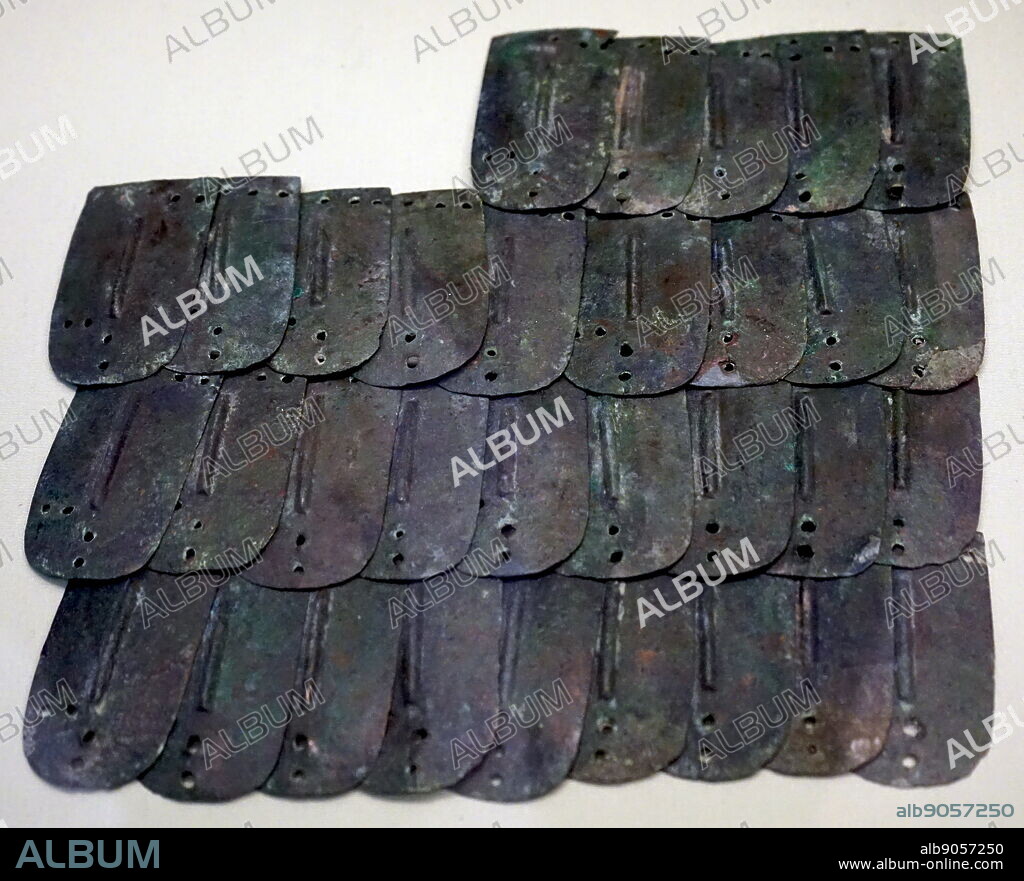 Ancient Assyrian scale armour made from segments of copper alloy. Dated 8th Century BC.