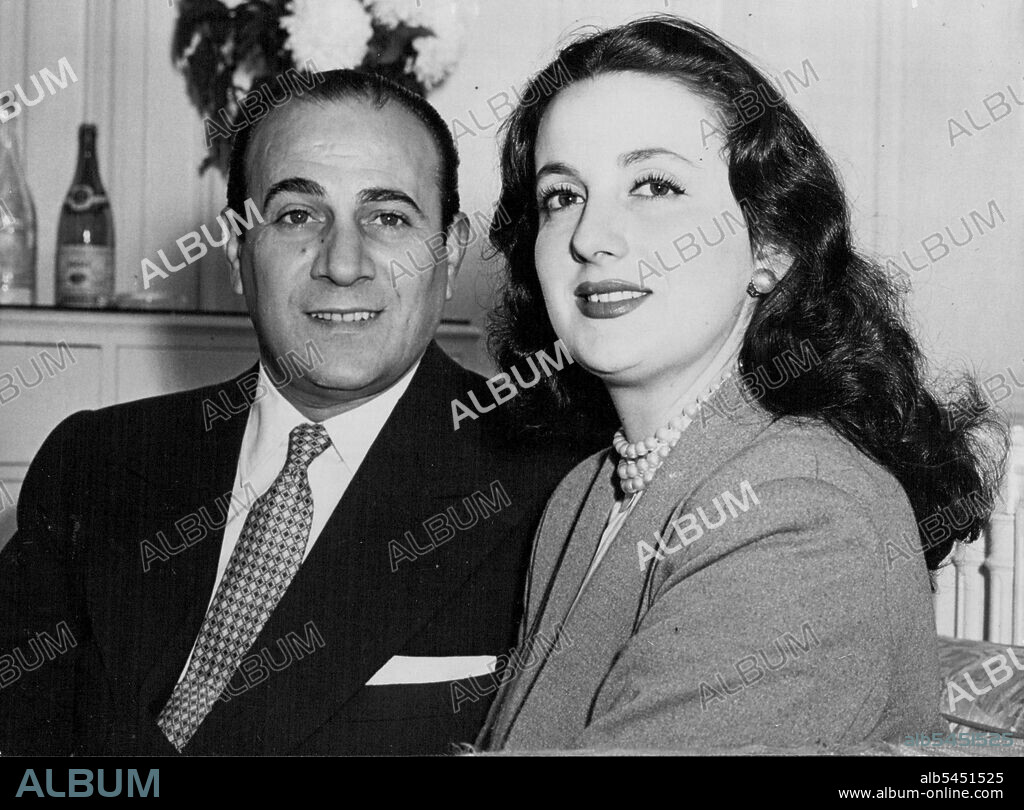 Rossi to Sing in London -- Tino Rossi and his wife Lilia seen together in the Savoy Hotel, London, today.Satisfying sight for corsica-born singer Tino Rossi and his wife Lilia is the Skyline of London, seen from a balcony of the Savoy Hotel, London. Rossi, internationally famous singer in both English and French, will perform in London for the first time, at the Piccadilly Theatre (October 16 to 28). His wife is the French Film Actress Lilia Vitte. They have been married there years and have a two year-old boy, Laurenz. October 15, 1950. (Photo by John Trievnor, Paul Popper Ltd.).