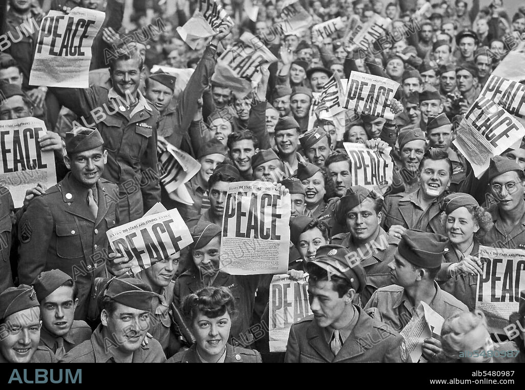 VE Day - Soldiers hold up the Stars and Stripes newspaper in celebration of the end of WWII in Europe May 8, 1945.