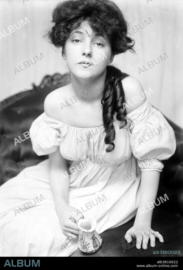 Nesbit photographed by Gertrude Kasebier at the request of Stanford White, circa 1900. Florence Evelyn Nesbit (December 25, 1884 - January 17, 1967) was a popular American chorus girl and model. In the early 20th century, her face and figure was everywhere, appearing in newspapers, magazine advertisements and calendars, making her a cultural celebrity. She posed for many respected artists of the era, notably Charles Dana Gibson, who idealized her as a "Gibson Girl." She had the distinction of being an early "live model," in an era when fashion photography was just beginning its ascendancy. She attracted the attention of socialite and architect Stanford White, who became her lover and achieved world-wide notoriety when her jealous husband, multi-millionaire Harry Kendall Thaw, shot and murdered White, leading to what the press would call "The Trial of the Century." In the 1920s, she became the proprietor of either a tearoom or speakeasy located in Manhattan. It was during this period and well into the 1930s that she struggled with alcoholism and morphine addiction. She published two memoirs, The Story of My Life (1914), and Prodigal Days (1934). Nesbit died in 1967 at the age of 82.