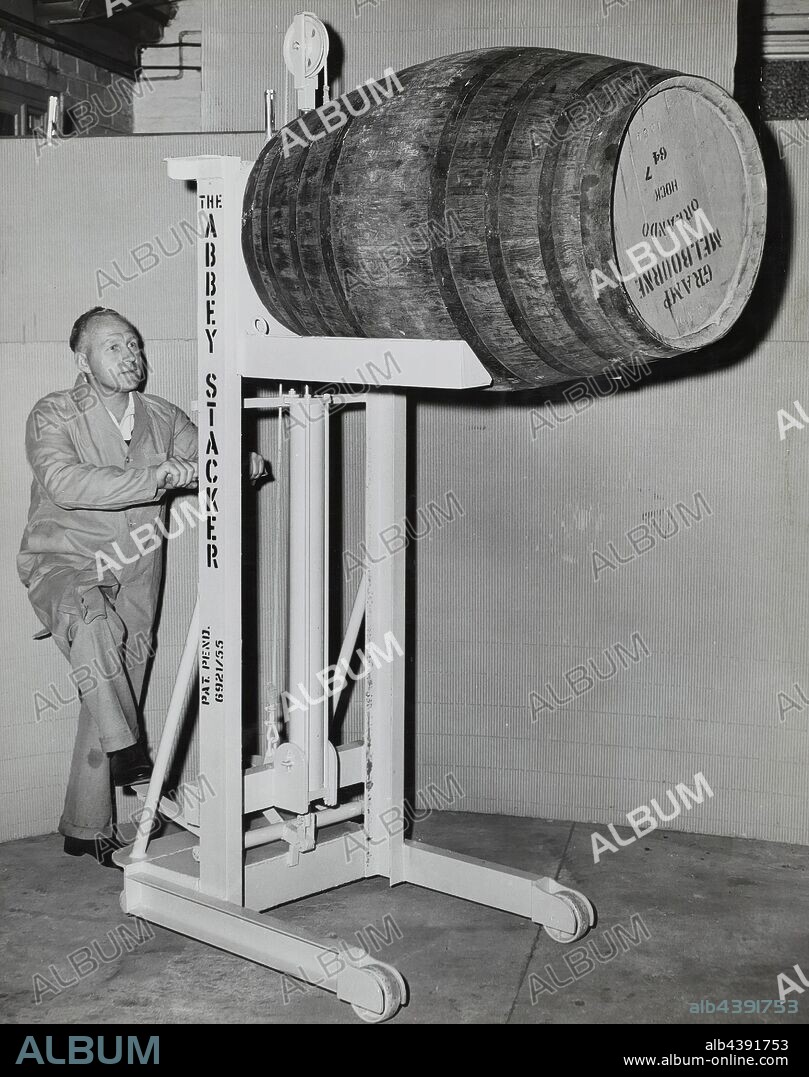 Photograph - Man With Gramp Wine Barrel, Melbourne, Victoria, circa 1940s, Black and white photograph depicting a man with a Gramp wine barrel in Melbourne, circa 1940s. It is part of a collection of photographs and marked printer's copy used in the preparation of trade literature promoting products manufactured by the Schumacher Mill Furnishing Works Pty Ltd. The items were originally housed in a wooden filing drawer.