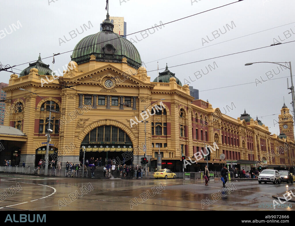 Flinders Street railway station, Flinders and Swanston Streets in Melbourne, Australia. It is the busiest station on Melbourne's metropolitan network and was the first railway station in an Australian city. The main station building, completed in 1909, is a cultural icon of Melbourne, with its prominent dome, arched entrance, tower and clocks one of the city's most recognisable landmarks. It is listed on the Victorian Heritage Register.
