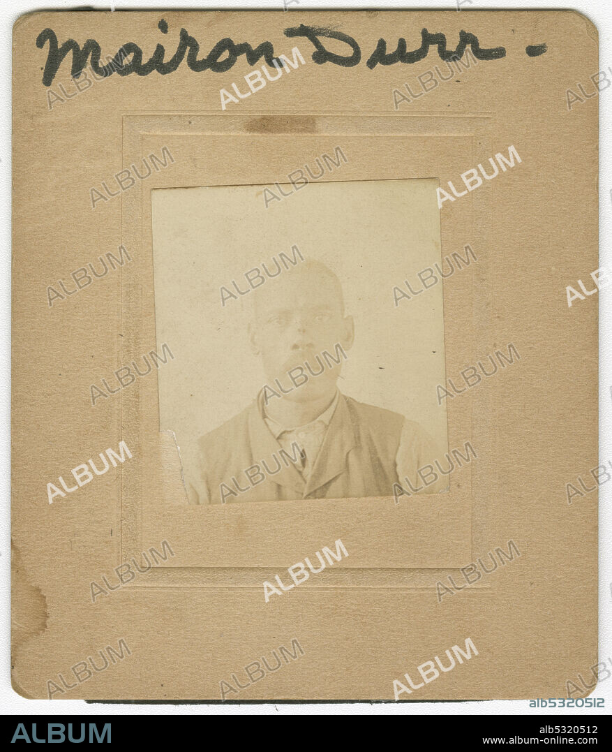 A sepia toned cartes-de-visite portrait of Marion [Mairon] Durr. He is dressed in a light colored shirt and darker colored vest. The photograph is off centered in the mount. Written at the center of the photograph at top is “Marion Durr.” There is no inscription on the back.