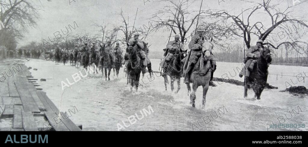 French cavalry soldiers traverse a flooded road during World War One, 1917.