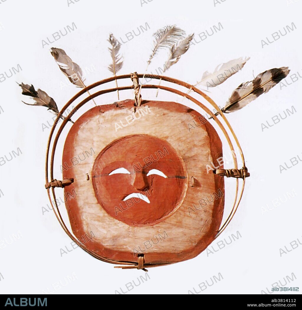 Inuit mask representing the Moon and stars. The Inuit, formerly referred to as Eskimos, are a group of indigenous peoples inhabiting the Arctic regions of Canada, Greenland, Russia and the United States. This carved and painted mask, used in Inuit shamanistic rites, bears the face of the Moon set in a white sky with attached feathers representing stars.
