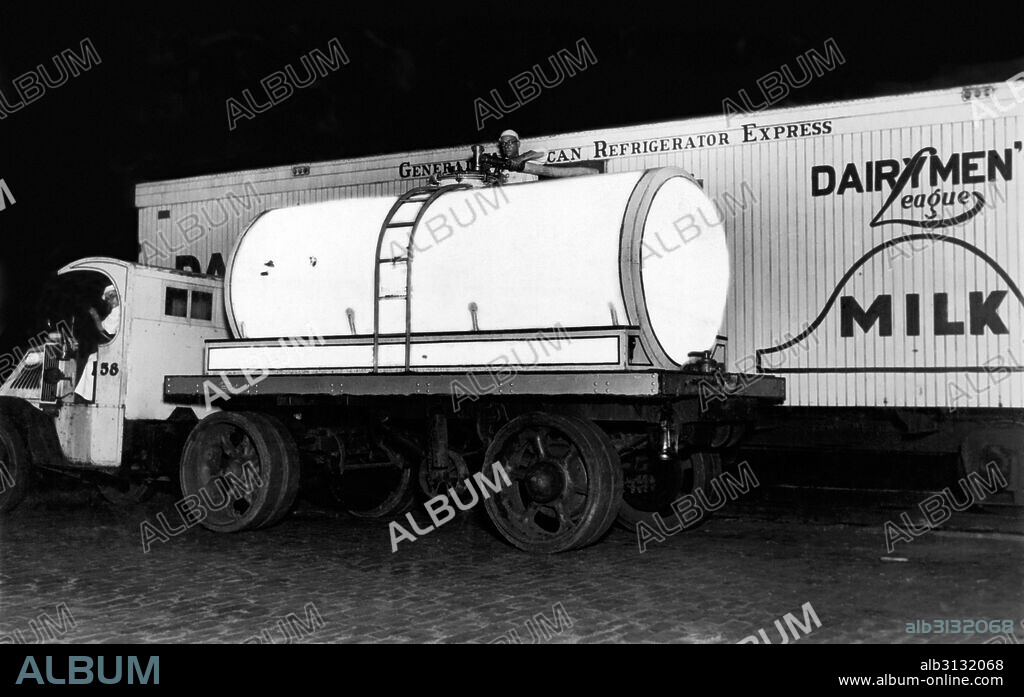 New York, New York:  c. 1928 A new Borden's MIlk truck shows the latest in milk transport. Both the truck and the train are equipped with seamless glass containers covered with cork that keep the milk at 37 degrees for16 hours with no ice. It takes one man only ten minutes to load the 8000 quart truck tank from the train tank, as opposed to the old method with three men taking 45 minutes to load 200 cans of milk.