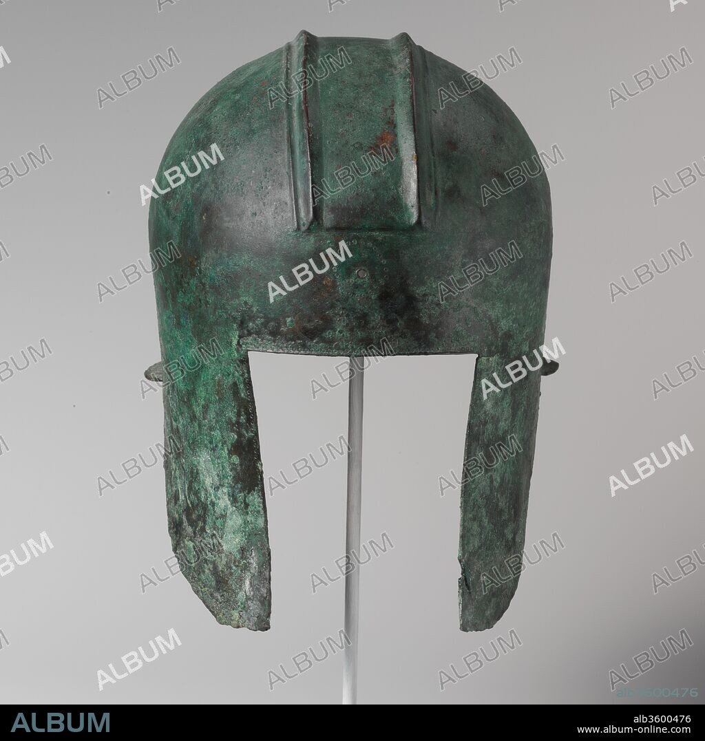 Bronze helmet of Illyrian type. Culture: Greek. Dimensions: H. 10 1/2 in. (26.7 cm)
Width: 7 3/4 in. (19.7 cm)
Depth: 9 1/2 in. (24.1 cm). Date: early 5th century B.C..
The borders of the helmet around the face are embellished with lightly traced circles.