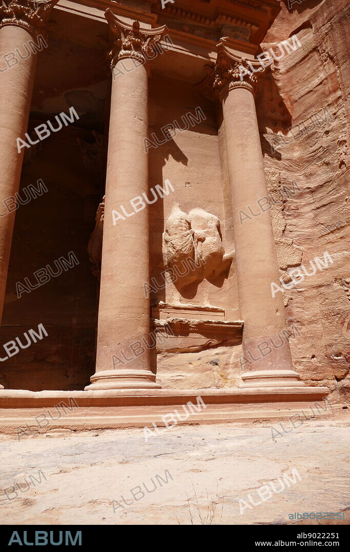 Al-Khazneh (The Treasury) a temple in the ancient Nabatean Kingdom city of Petra, Jordan. The structure was carved out of a sandstone rock face and is believed to have been the mausoleum of the Nabatean King Aretas IV in the 1st century AD. It is one of the most popular tourist attractions in both Jordan and the region. In 1812, the city of Petra and Al-Khazneh was rediscovered by Swiss explorer Johann Ludwig Burckhardt.