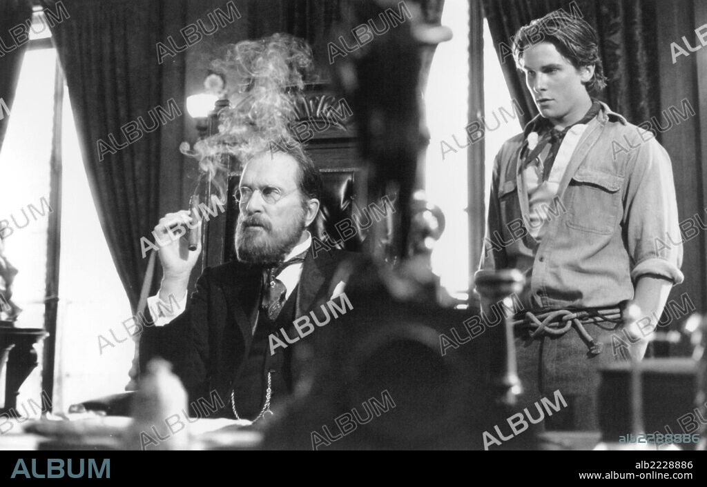 CHRISTIAN BALE and ROBERT DUVALL in NEWSIES, 1992, directed by KENNY ORTEGA. Copyright WALT DISNEY PRODUCTIONS.