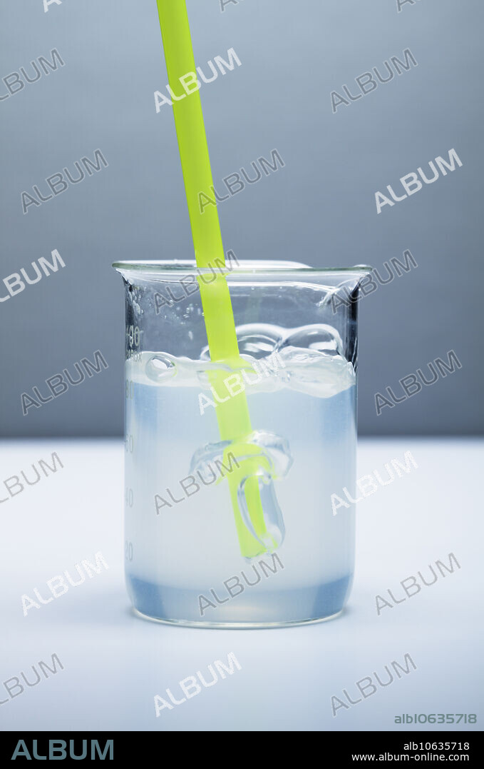 Carbon dioxide test, Photo 3 of 4. Lime water is a saturated calcium hydroxide (Ca(OH)2) solution. When carbon dioxide (CO2) is bubbled through lime water, calcium carbonate (CaCO3) precipitates out of the solution giving the solution a cloudy appearance. The reaction is: Ca(OH)2(aq) + CO2(g) -> CaCO3(s) + H2O(l). This series shows the solution becoming progressively cloudy as carbon dioxide is being bubbled through a drinking straw. Image 3 of 4.