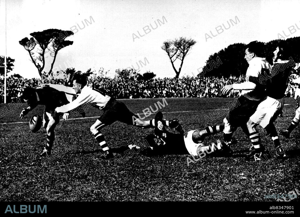 Wallabies Defeat Cornwall & Devon By 17 Points To 7 -- M. L. Howell (extreme left) Australia, being tackled, while on right A. J. Solomon (Cornwall & Devon) is being collared by T. Allen, the Australian Vice-Captain.In their first match of the English tour, the Australian Rugby touring team-the Wallabies-defeated Cornwall & Devon by 17 points to 7 at Camborne. September 13, 1947. (Photo by Sport & General Press Agency Limited).