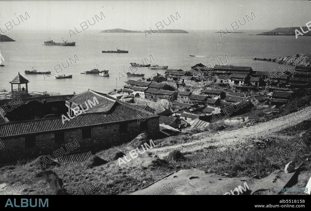 Chinese Attack Chiang's Islands -- The village of Tashatou nestling among hills surrounding the harbour on lower Tachen Island. Upper Tachen in the background. Picture taken last November. The Tachen Islands, only 14 miles from the Mainland, hold about 14,500 civilians and 20,000 troops.The Chinese Nationalist defense ministry announced in Taipei today January 18 that communist Chinese forces may have captured the island of Yikiangshan, 200 miles north of Formosa, in a combined air land and sea operation. It was also reported that communist forces had rained more than 200 bombs on the nearby Tachen Islands. January 18, 1955. (Photo by Associated Press Photo).