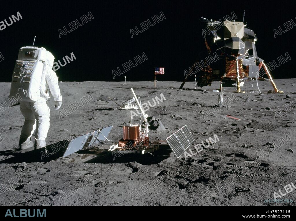 Astronaut Edwin E. Aldrin Jr., lunar module pilot, is photographed during the Apollo 11 extravehicular activity (EVA) on the moon. He has just deployed the Early Apollo Scientific Experiments Package (EASEP). In the foreground is the Passive Seismic Experiment Package (PSEP); beyond it is the Laser Ranging Retro-Reflector (LR-3); in the center background is the United States flag; in the left background is the black and white lunar surface television camera; in the far right background is the Lunar Module (LM). Astronaut Neil A. Armstrong, commander, took this picture with a 70mm lunar surface camera.