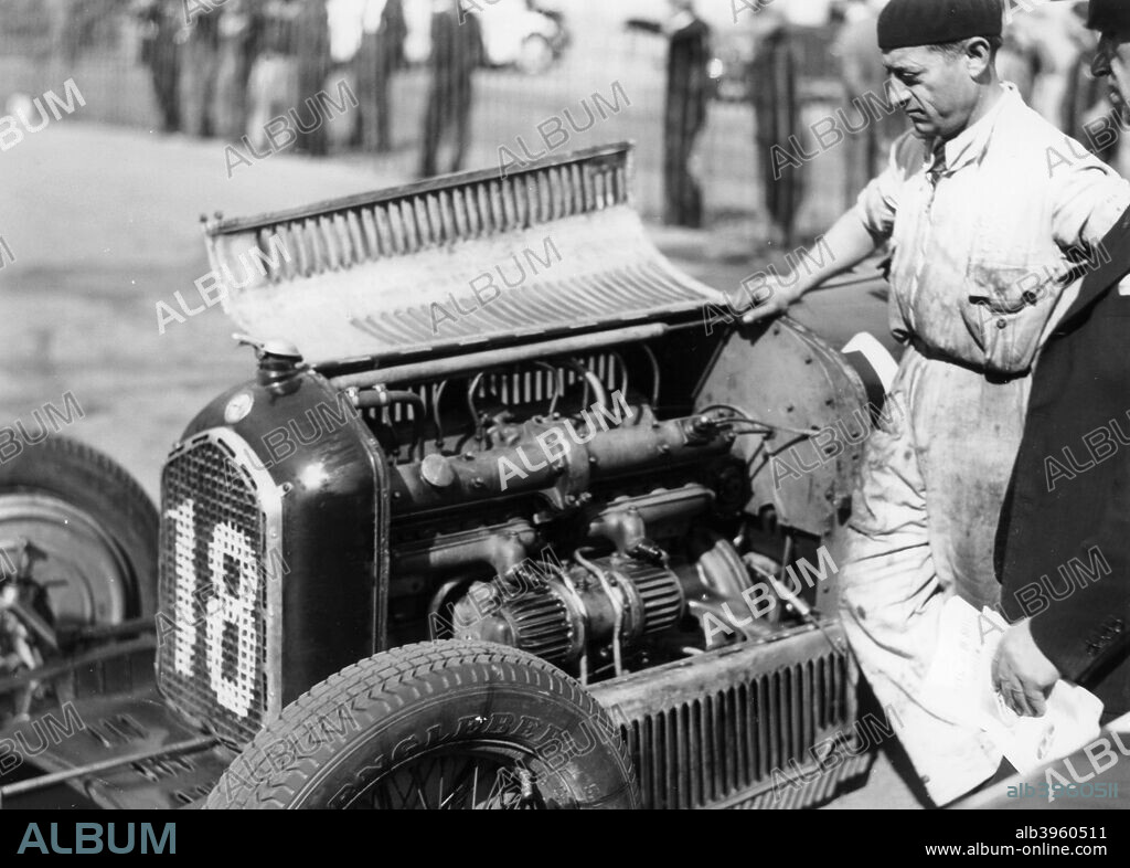 Attilio Marinoni, chief mechanic of Scuderia Ferrari, with an Alfa Romeo, 1934. Scuderia Ferrari raced Alfa Romeo cars in the 1930s. It was not until 1947 that the first 'true' Ferrari single seater racing car appeared. Marinoni came to Ferrari from Alfa Romeo in 1932 when Alfa Romeo announced their withdrawal from motor racing. As well as being a mechanic, he also competed as a racing driver.
