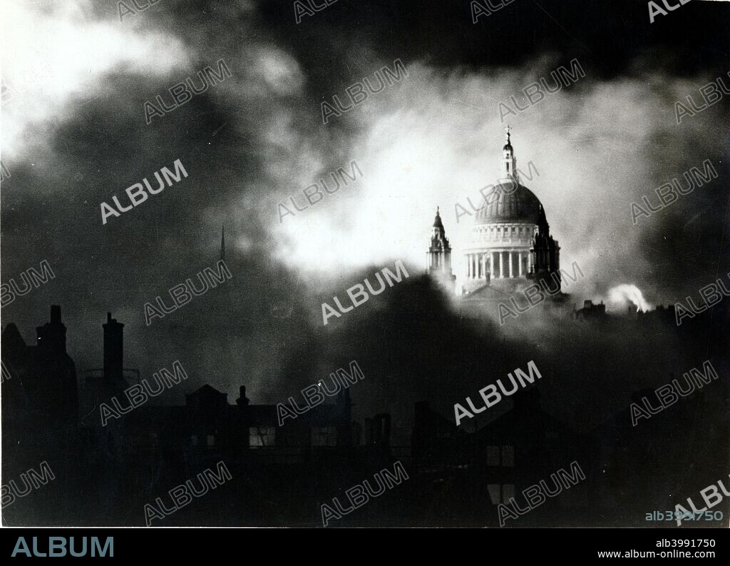 St Paul's Cathedral, London, during the Blitz, World War II, 29 December 1940. This iconic photograph shows the dome of Sir Christopher Wren's cathedral intact as the city around it burns from German incendiary bombs. The raid of 29 December was one of the heaviest on London, causing a firestorm in the City that has been described as the Second Great Fire of London.