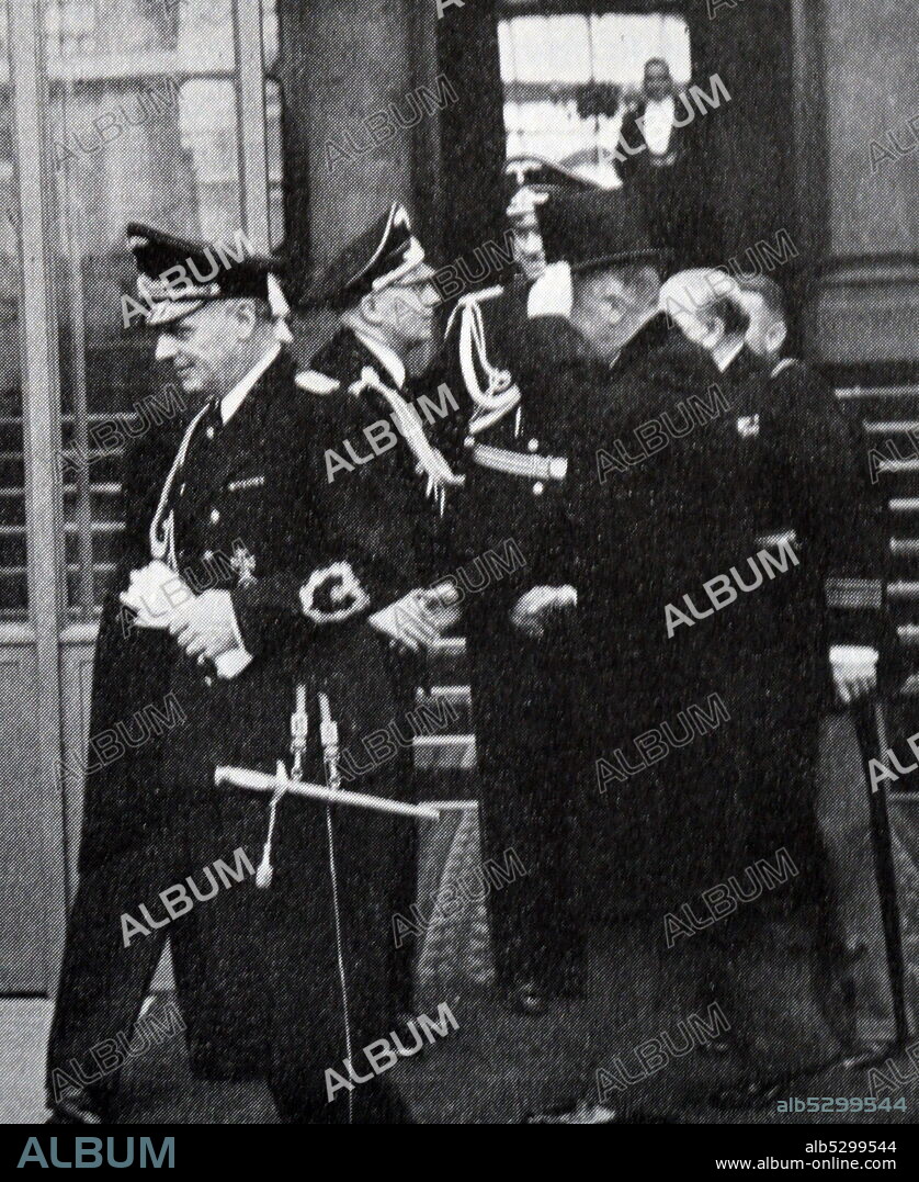 Black and white photograph of German Foreign Minister Joachim von Ribbentrop (1893-1946) and Georges Bonnet (1889-1973) signing a non-aggression pact.