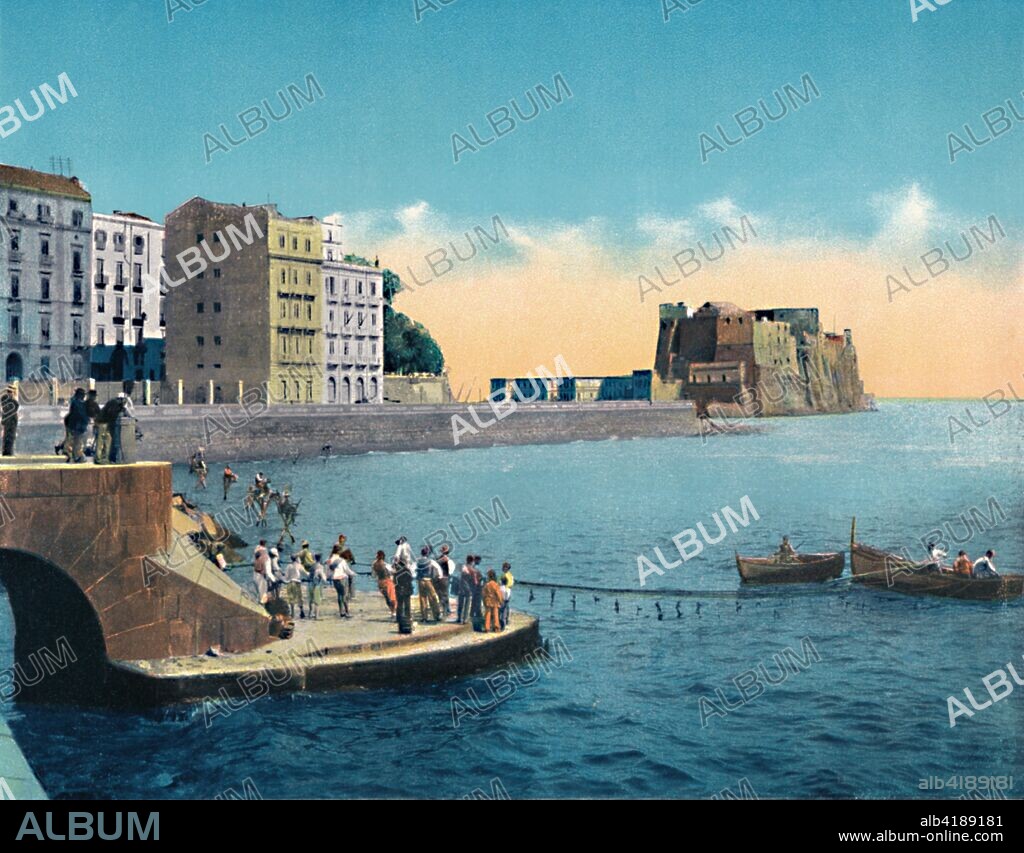 'Napoli - Via Partenope E Castello Dell'Ovo', c1900. Located on the former island of Megaride, now a peninsula, on the Gulf of Naples in Italy the castle is the oldest standing fortification in Naples with current appearance dating from Aragonese domination (15th century). From "Napoli".