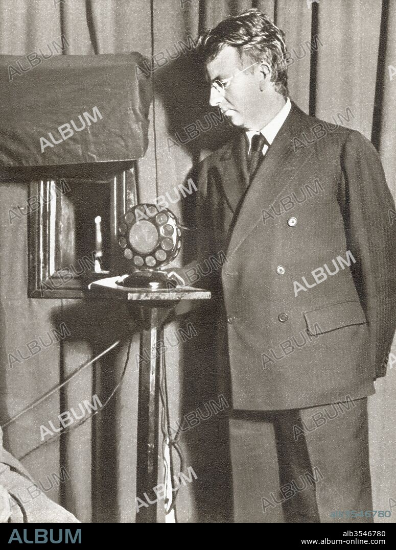 John Logie Baird, 1888 - 1946. Scottish engineer and inventor of the world's first practical, publicly demonstrated television system. Seen here watching the first televised play in 1930. From The Story of 25 Eventful Years in Pictures, published 1935.