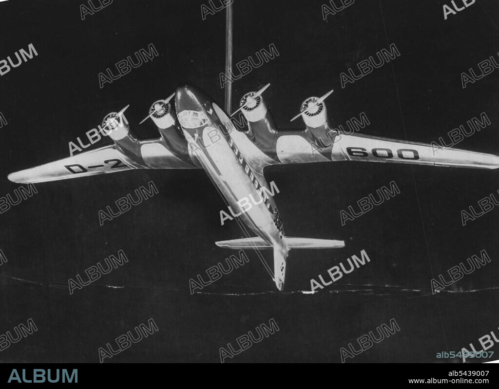 Herr Hitler's New Aeroplane, Specially Built For His Personal Use -- A model of Herr Hitler's New plane, as it will look when finished. This model has been presented to the fuhrer by his pilots. Herr Hitler is having built for his personal use a huge focke-wolf "Condor" four-engined plane of the same type that made the first Berlin-New York crossing last summer. The interior will be most artistically decorated to comply with the fuhrer's ideas. It will also enable him to hold conferences in the.