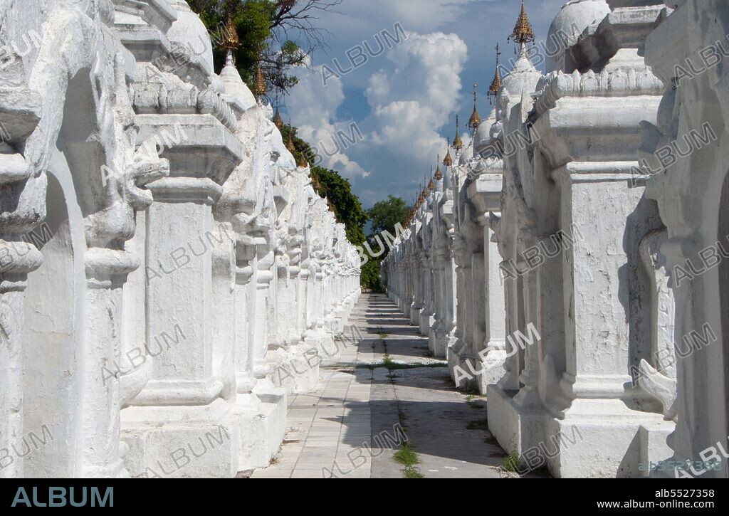The entire Tipitaka Pali canon of Theravada Buddhism is set on 729 marble slabs, each with 80 to 100 lines of text, originally in gold ink, on both the obverse and the reverse sides. Each stone is three and a half feet wide, five feet tall and five inches thick and housed in a <i>kyauksa gu</i> or a small cave-like stupa. Kuthodaw Pagoda, literally meaning Royal Merit Pagoda, and formally titled Mahalawka Marazein, is a Buddhist temple and stupa located in Mandalay, central Burma. It lies at the foot of Mandalay Hill and was built during the reign of King Mindon (1808—78). The stupa itself, which is gilded above its terraces, is 57 m (188 ft) high, and is modelled after the Shwezigon Pagoda at Nyaung-U near Bagan. In the grounds of the pagoda are 729 'kyauksa gu' or stone-inscription caves, each containing a marble slab inscribed on both sides with a page of text from the Tipitaka, the entire Pali Canon of Theravada Buddhism. The stone inscriptions are considered to be the largest book in the world. Mandalay, a sprawling city of more than 1 million people, was founded in 1857 by King Mindon to coincide with an ancient Buddhist prophecy. It was believed that Gautama Buddha visited the sacred mount of Mandalay Hill with his disciple Ananda, and proclaimed that on the 2,400th anniversary of his death, a metropolis of Buddhist teaching would be founded at the foot of the hill.