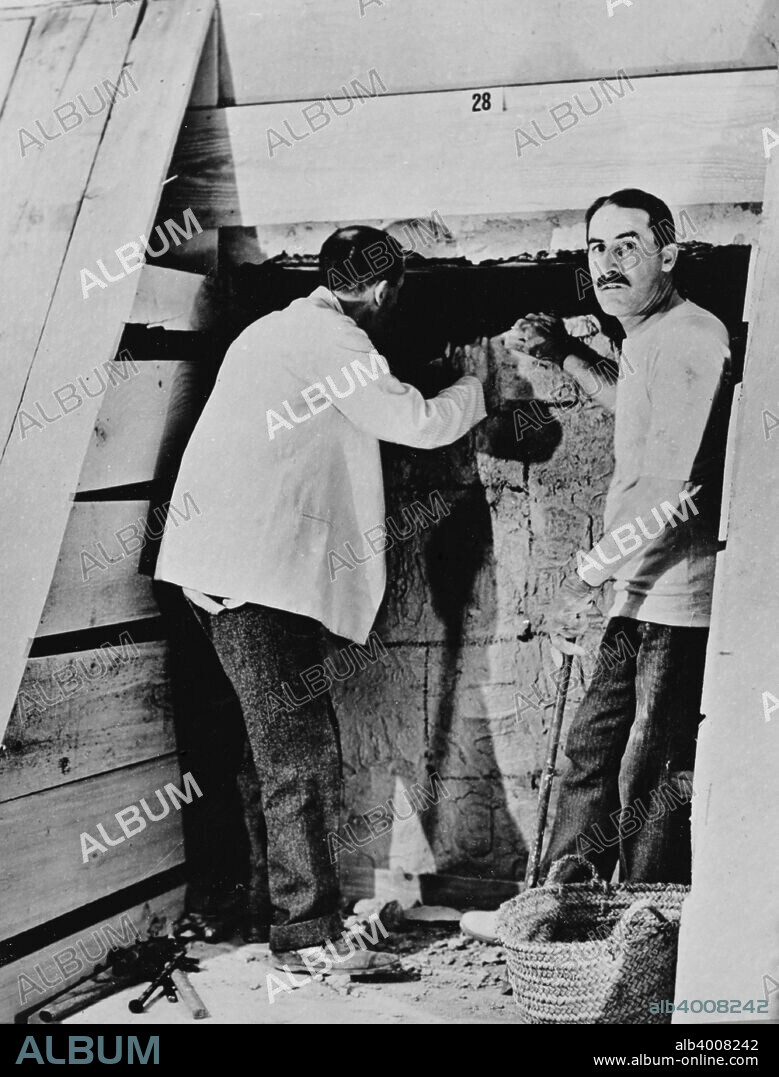 Howard Carter and a colleague excavating a tomb in the Valley of the Kings, Egypt, 1922. Carter's (1873-1939) discovery of Tutankhamun's tomb in 1922 was one of the most astounding discoveries in archaeology. Tutankhamun was a previously unknown pharaoh whose name had been eradicated from historical records by one of his successors because of his association with the heretical pharaoh Akhenaten, who was Tutankhamun's father-in-law. Consequently his tomb, uniquely, had remained undisturbed by grave robbers.