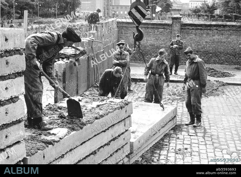 The Berlin Wall. (Building began on 13 August 1961). East German workers constructing the Wall. Photo.