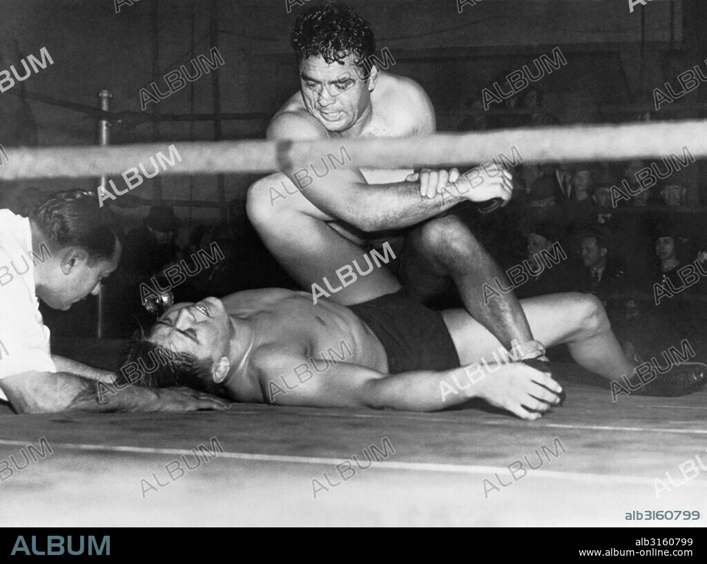 Washington, D.C.:   December 13, 1934 World wrestling champion Jim Londos applies one of his famous ankle twisters to the prostrate Vic Christy in their championship match last night.