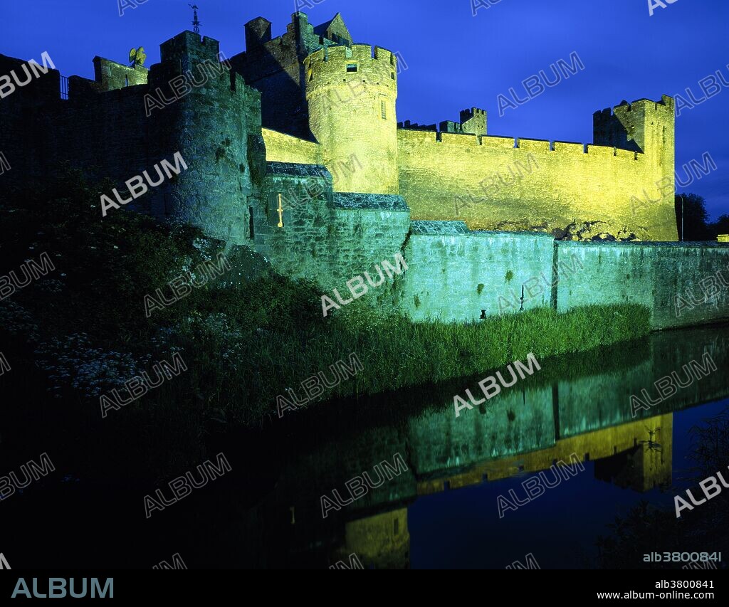 View shows the castle with evening illumination. Once the seat of the powerful Butler family, Cahir Castle is one of Ireland's largest and best preserved castles. The castle is on an island in the River Suir, and was built in 1142 by Conor O'Brien, Prince of Thomond.
