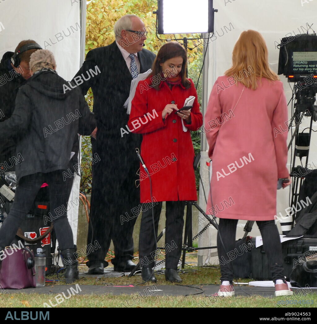 Tamara Cohen (red coat) a Sky News political correspondent prepares for interviews on College Green, Parliament, London. September 2019.