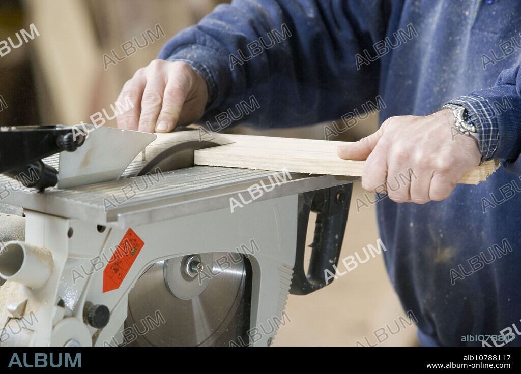 Carpenter cutting wood with electrical saw. Wood carpentry.