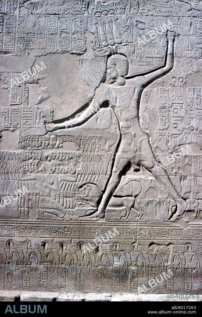 Detail of a relief on the first Pylon of the Pharaoh smiting his enemies, Temple of Khnum, Esna, Egypt, Ptolemaic and Roman Periods.