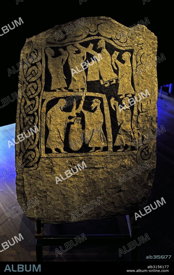 Runic Stone. Upper area: men with drinking horns. Bottom zone: two men fighting with swords. Probably Odin snatching mead from giant Suttung. Historic museum. Stockholm. Sweden.