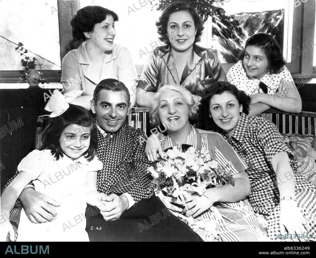 A new picture of Eddie Cantor, and his family on the occasion of his home coming from hospital following his recent long illness. His latest picture is "Strike Me Pink". November 15, 1937.